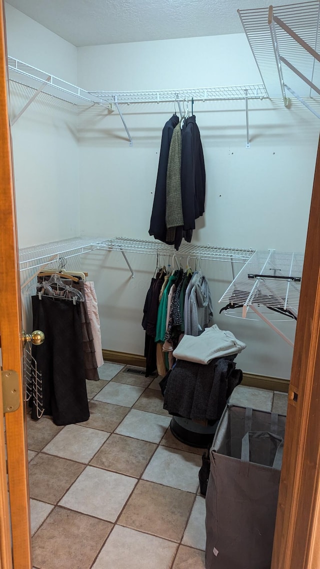 spacious closet featuring light tile patterned flooring