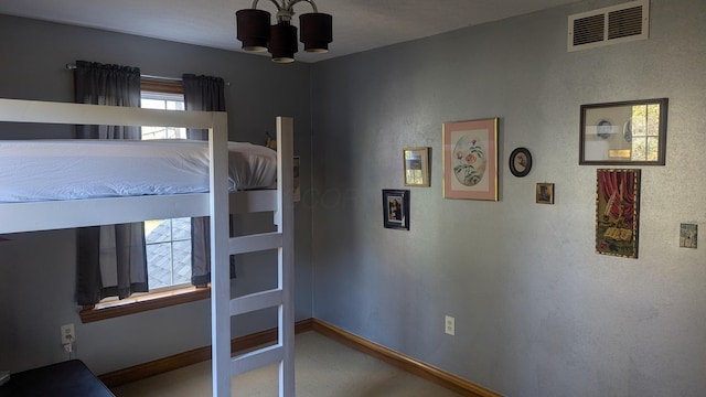 unfurnished bedroom with a chandelier