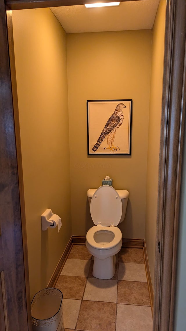 bathroom featuring tile patterned floors and toilet