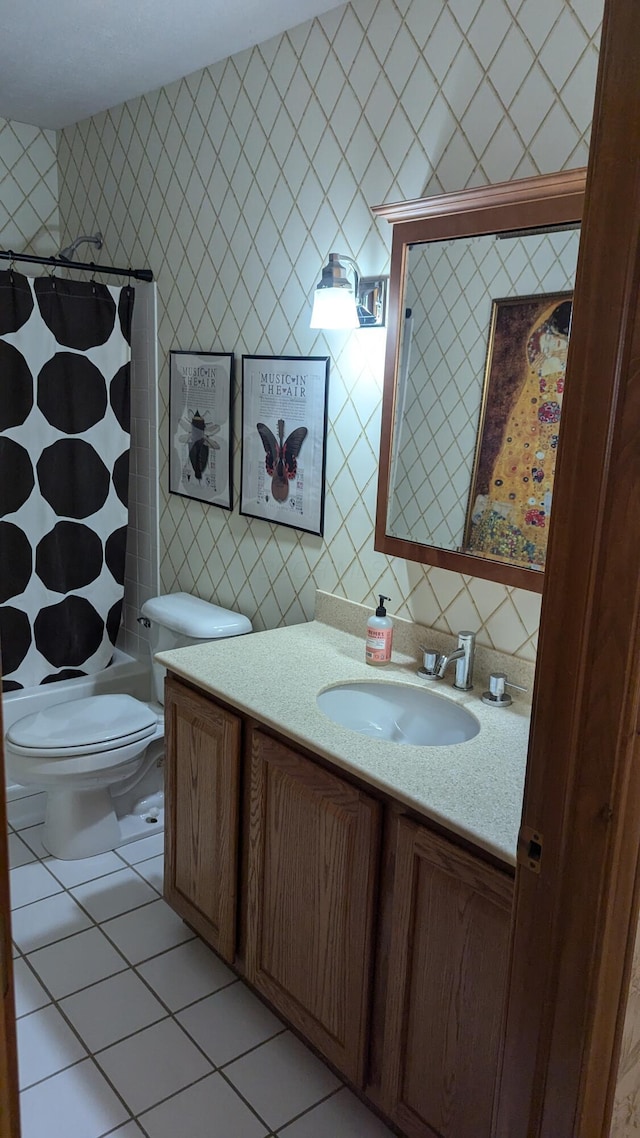 bathroom with tile patterned flooring, vanity, toilet, and tile walls