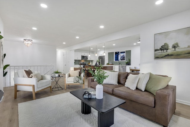 living room with light hardwood / wood-style flooring and sink