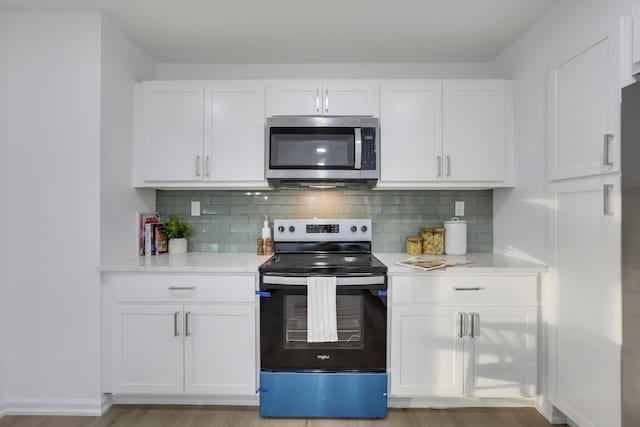 kitchen with white cabinets and appliances with stainless steel finishes