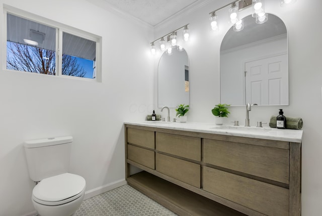 bathroom featuring tile patterned floors, ornamental molding, a textured ceiling, vanity, and toilet