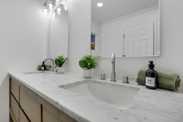 bathroom featuring vanity and ornamental molding