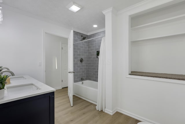 bathroom with hardwood / wood-style flooring, shower / bath combination with curtain, a textured ceiling, and vanity