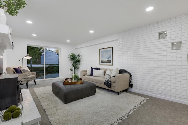 living room featuring carpet flooring and brick wall