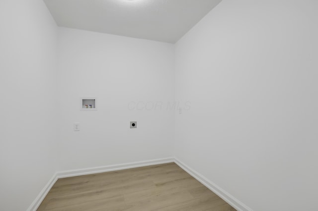 washroom with electric dryer hookup, hookup for a washing machine, and light wood-type flooring