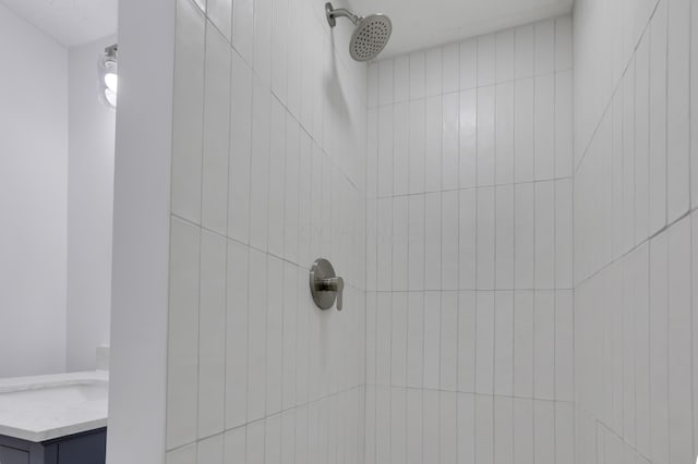 room details with tiled shower and vanity