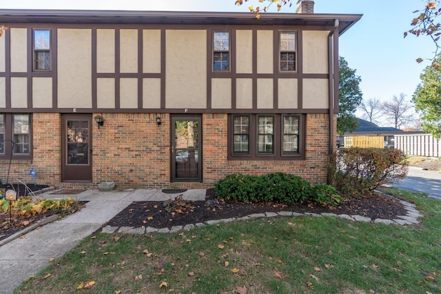 tudor house featuring a patio and a front yard