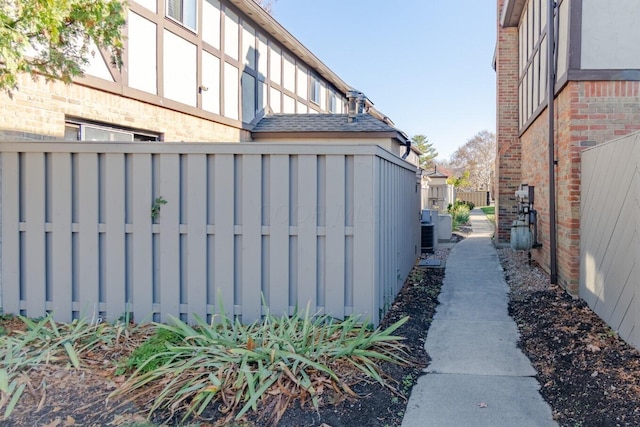 view of side of home with central air condition unit