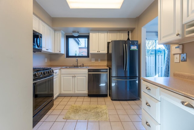 kitchen featuring white cabinets, sink, a healthy amount of sunlight, and black appliances