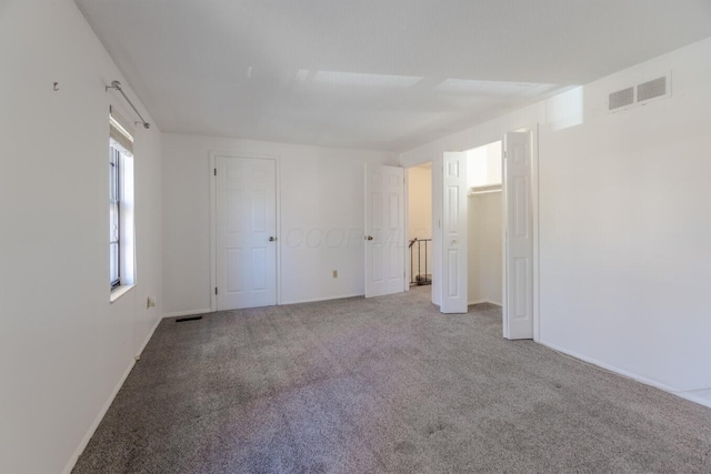 unfurnished bedroom with light colored carpet