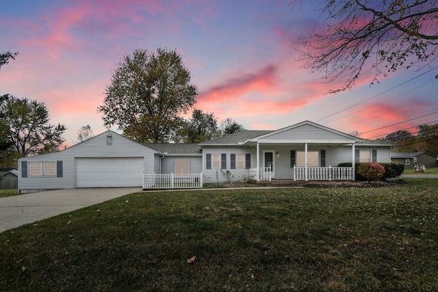 ranch-style house featuring covered porch, a yard, and a garage