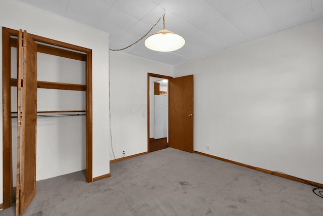 unfurnished bedroom with light carpet and a closet