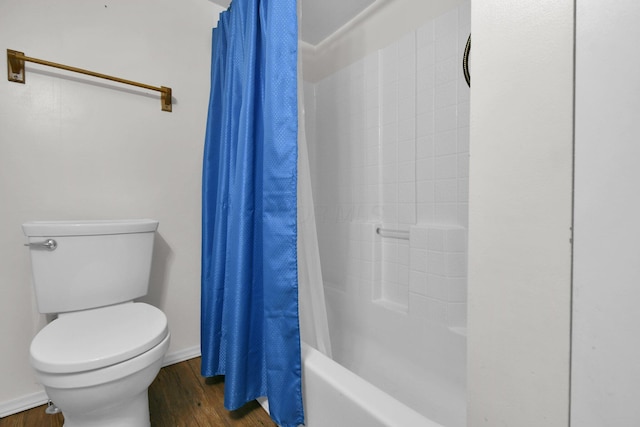 bathroom with hardwood / wood-style floors, shower / tub combo, and toilet