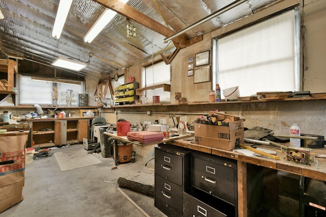 misc room with a workshop area and concrete flooring