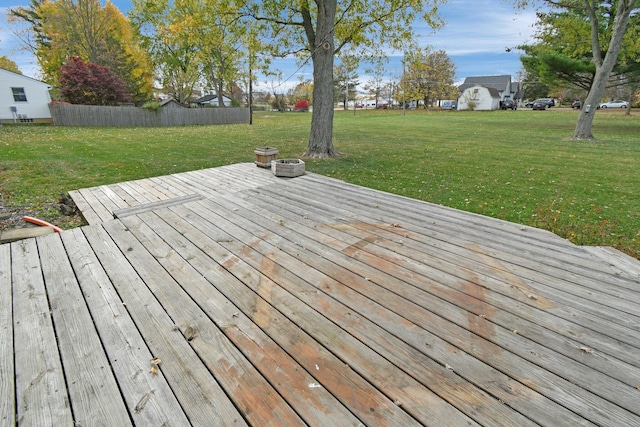 wooden terrace featuring a lawn