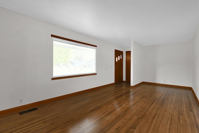 unfurnished room with dark hardwood / wood-style floors