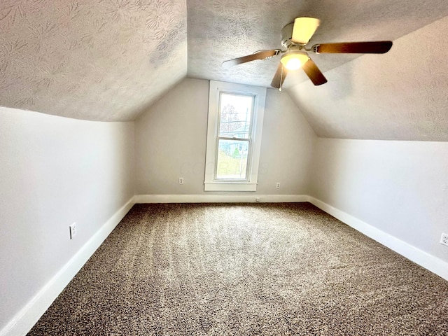 bonus room with carpet, a textured ceiling, ceiling fan, and lofted ceiling