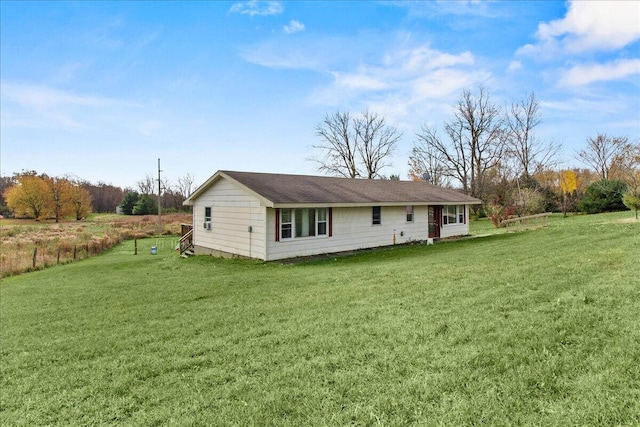 rear view of property with a yard