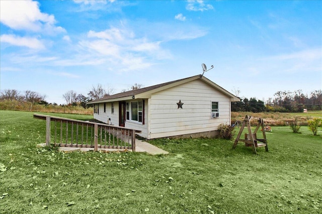 view of property exterior featuring a lawn and a deck