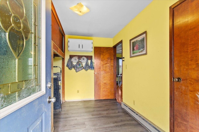 hall featuring baseboard heating and dark hardwood / wood-style flooring