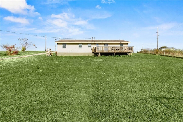 back of house with a lawn and a deck