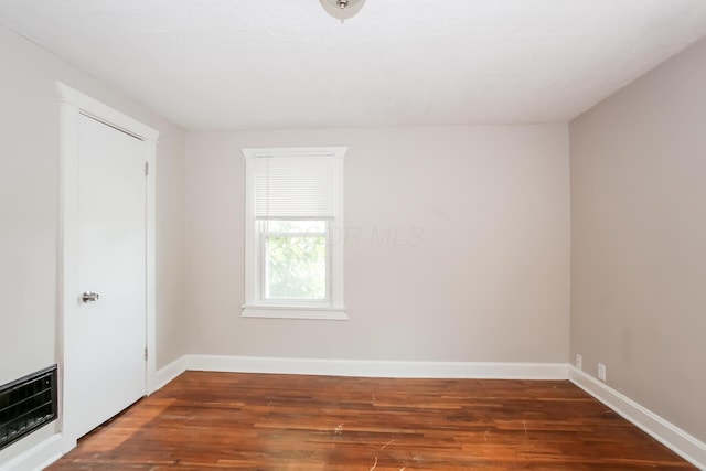 unfurnished room featuring wood finished floors and baseboards