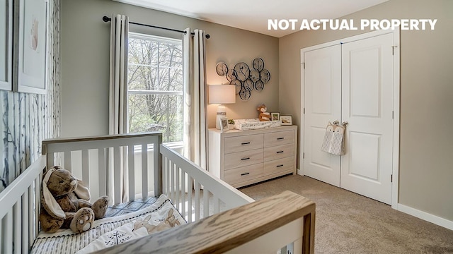 bedroom with light carpet, a closet, and a crib