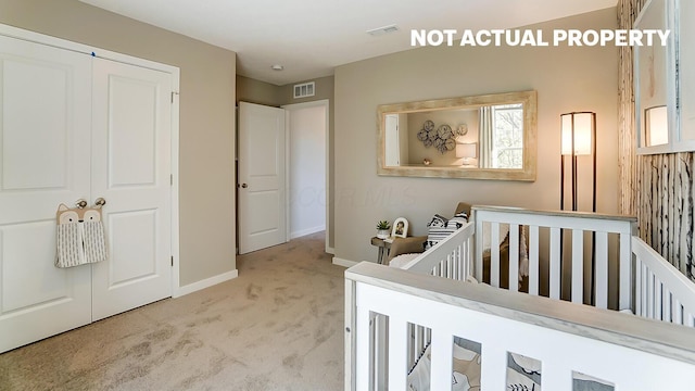 carpeted bedroom featuring a crib and a closet