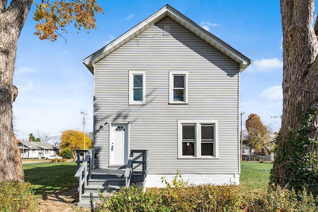 back of house with a lawn