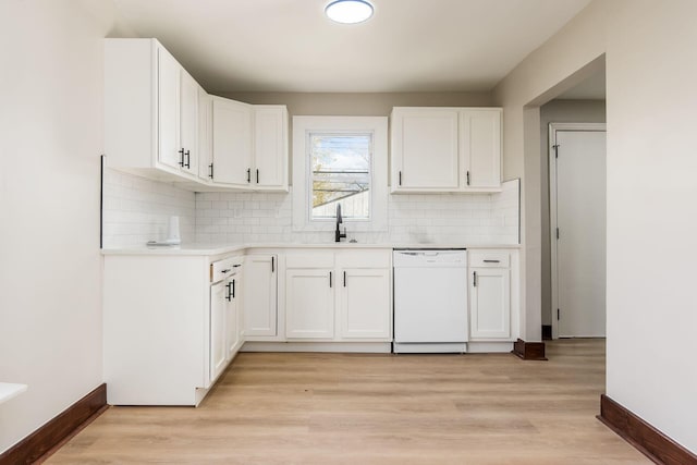 kitchen featuring white cabinetry, dishwasher, sink, backsplash, and light wood-type flooring