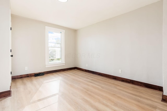 empty room with light hardwood / wood-style flooring