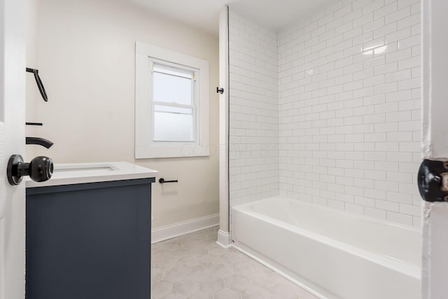 bathroom with tile patterned flooring, vanity, and tiled shower / bath