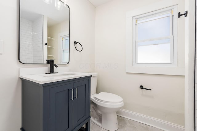 bathroom with tile patterned flooring, vanity, and toilet