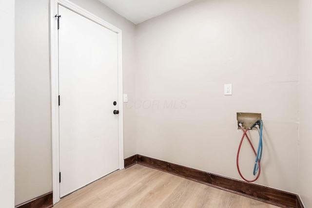 laundry room with washer hookup and light hardwood / wood-style floors