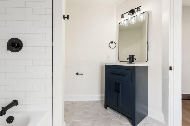 bathroom with tile patterned floors, vanity, and tiled shower / bath combo