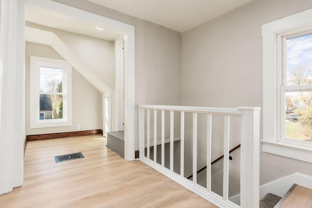 hallway with plenty of natural light and light wood-type flooring