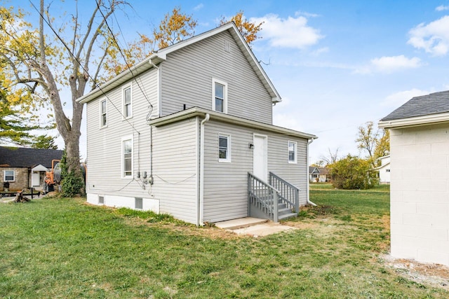 rear view of house with a yard