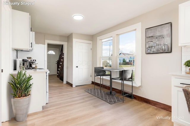 kitchen featuring white cabinets and light hardwood / wood-style floors