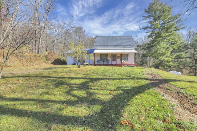 760 Henpeck Rd, Utica, OH 43080 - farmhouse-style home featuring a porch, a front lawn, and a metal roof