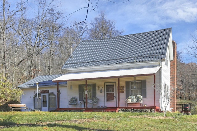 760 Henpeck Rd, Utica, OH 43080 - farmhouse-style home featuring a porch, a metal roof, a chimney, and a front yard