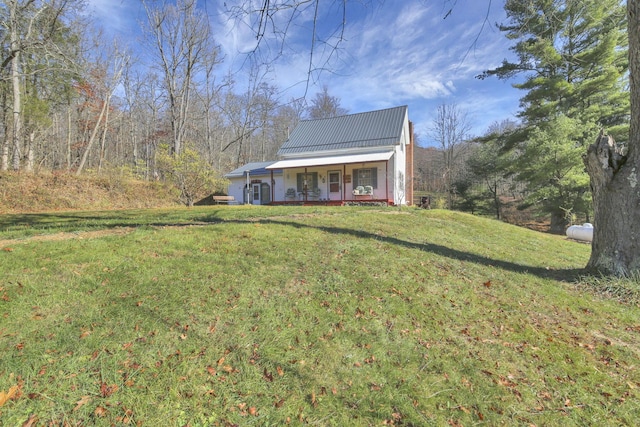 760 Henpeck Rd, Utica, OH 43080 - view of front facade featuring a porch, a front lawn, and a metal roof