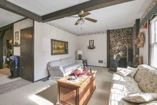 760 Henpeck Rd, Utica, OH 43080 - carpeted living room with beam ceiling, ceiling fan, a textured ceiling, a wood stove, and plenty of natural light