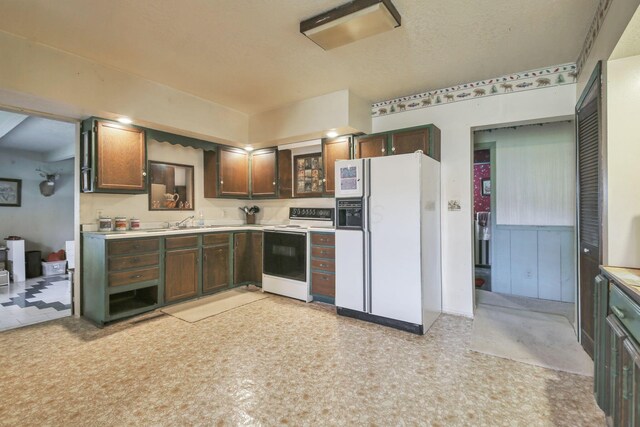 760 Henpeck Rd, Utica, OH 43080 - kitchen with white appliances, light countertops, light flooring, and dark brown cabinets