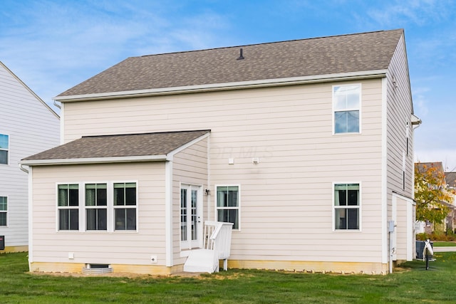 rear view of property with a yard