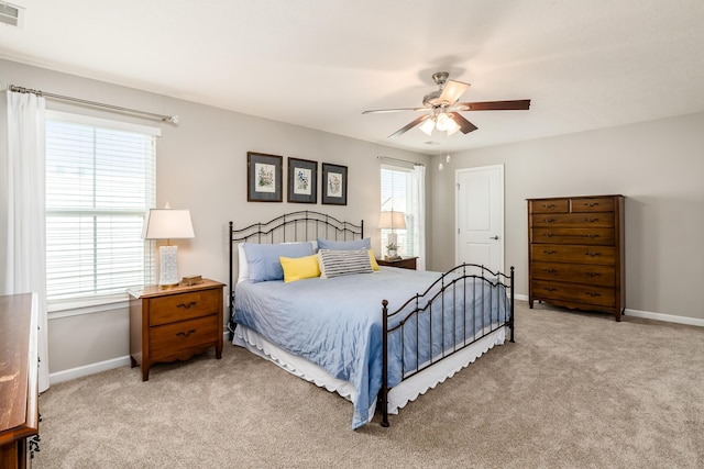 bedroom featuring light carpet and ceiling fan