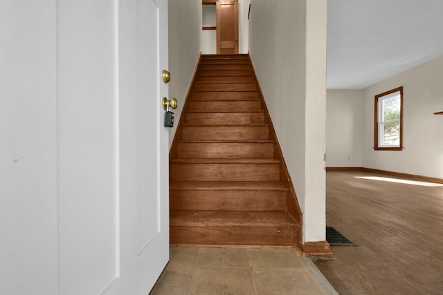 staircase with tile patterned flooring