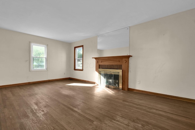 unfurnished living room featuring hardwood / wood-style floors and a fireplace