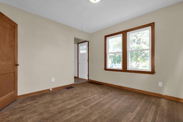 empty room featuring dark wood-type flooring